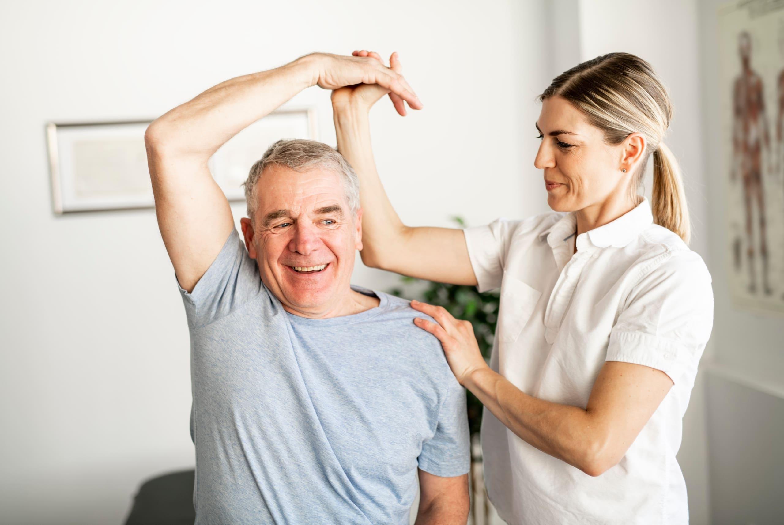 Older man performing exercises in physical therapy